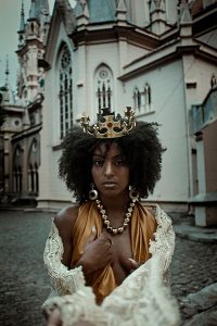 woman with gold crown and necklace