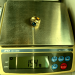 15.4 gram gold ring on scale