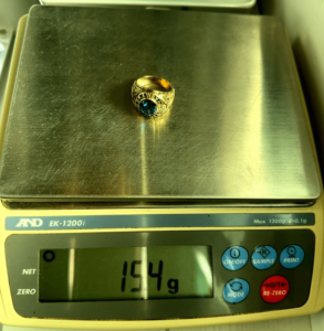 15.4 gram gold ring on scale