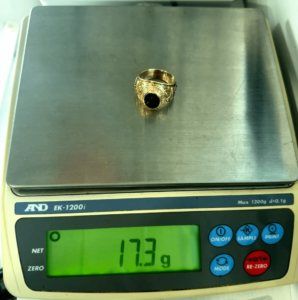 17.3 gram gold ring on scale