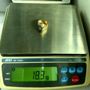 18.3 gram gold ring on scale