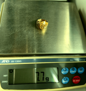 7.7 gram gold ring on scale