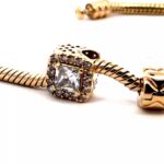 closeup of pandora moments yellow gold charm bracelet