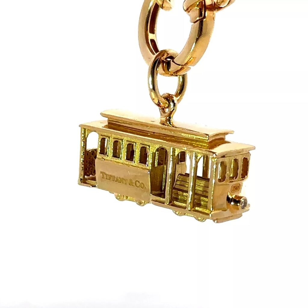 gold charm of a cable car